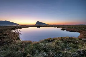Swampland: Swampland, dusk is reflected in a small round lake