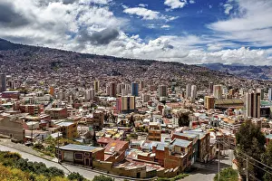 Tower: Sweeping city view with hilly landscape and clouds