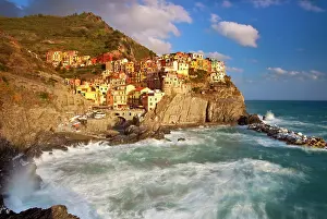 Wavy: Swirling ocean at the foot of medieval town