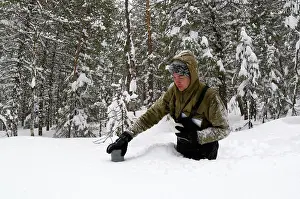Monitoring: Taking a snow depth measurement - boreal forest