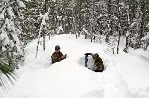 Monitoring: Taking a snow depth measurement in a boreal forest