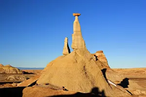 Amidst: Tall Hoodoo - eroded clay sculptures with rocks