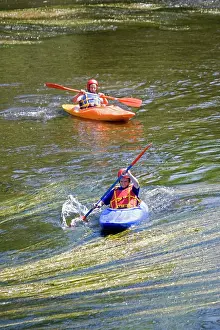 Paddling: Teenage boys paddling canoes down River Wye, Lower