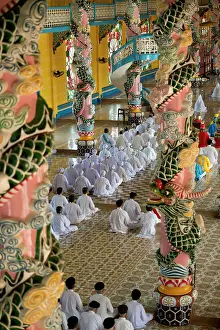 Ninh: Temple Interior with Caodaist disciples sitting