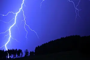 Flash: Thunderstorm, lightning striking a forest