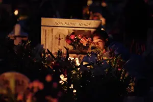 Township: A tomb with candles before it, in the cemetery