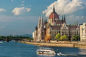 Built: Tour boat passes Hungary's Parliament, built between