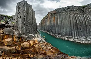 Columns: Tourist at Studlagil Canyon, basalt columns, Egilsstadir
