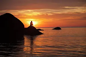 Destinations: Tourist watching the sunset on Palolem Beach, Goa