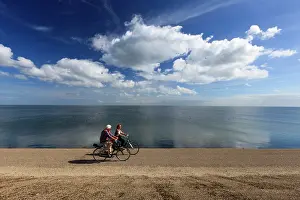Bicycles: Tourists - two cycling along the reinforced East