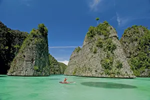 Lifestyle: Tourists kayaking in bay, Misool Island