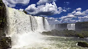 Waterfalls: Towering waterfalls flow powerfully under dramatic skies