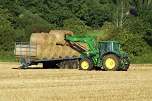 Trailer: Tractor carrying bales of hay and loading onto