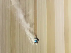 Raising: Tractor at field work. Aerial view. Drone shot