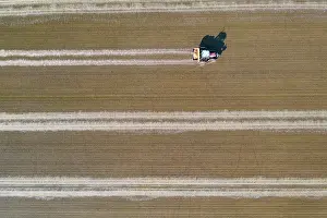 Delta: Tractor sowing rice seeds in a flooded rice field