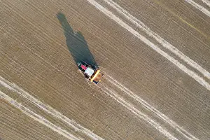 Delta: Tractor sowing rice seeds in a flooded rice field