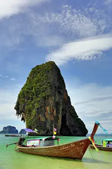 300517: Traditional Thai long tail boat and limetone rock format