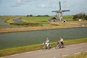 Cycling: Traditional Windmill - with tourists cycling past