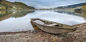 Typical: Traditional wooden rowing boat on the shore of Lake