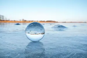 Transparent: Transparent glass orb on a frozen lake with ice