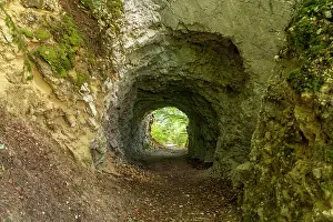 Artificial: Tunnel in the rock on the hiking trail around the