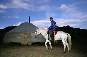 Yurts: Tuvinian in traditional clothes on a horse wearing