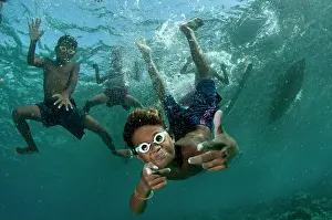 Kids: Underwater boys wearing goggles playing in the water