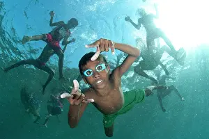 Kids: Underwater boys wearing goggles playing in the water