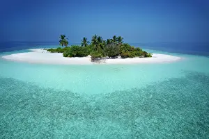 Leave: Uninhabited palm island with sandy beach, offshore