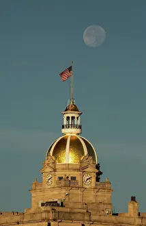 Moon: USA, Georgia, Savannah. Moon setting over gold dome