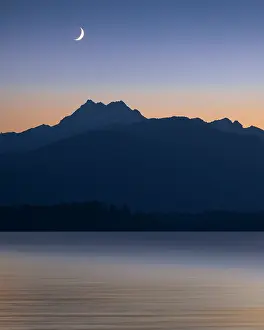 Canal: USA, Washington State, Seabeck. Crescent moon at