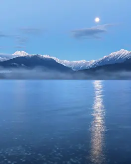 Canal: USA, Washington State, Seabeck. Moon setting over