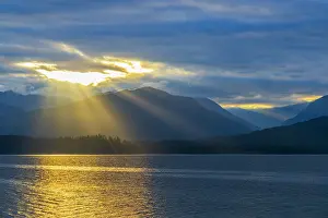 Canal: USA, Washington State, Seabeck. Sunburst over Hood