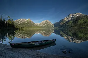 Lifestyle: USA, Wyoming. Canoe and Mountains seen from Leigh Lake