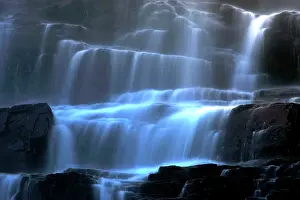 Cascading: Veil fall - water cascading down Tvindefossen waterfall
