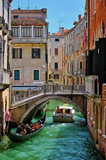 2018: VENICE, ITALY, JULY 19, 2018: Narrow canal betwe