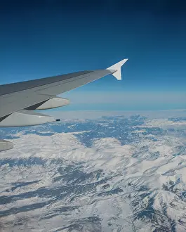 Plane: View of mountains and snowy landscape from the airplane