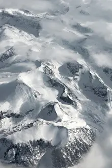 Plane: View from the plane to snow-covered mountainous