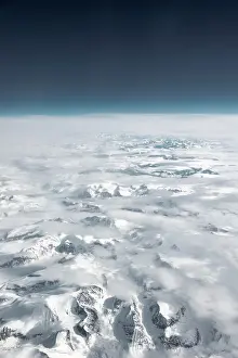 Plane: View from the plane to snow-covered mountainous