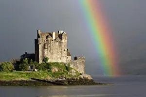 Prismatic: View of restored castle on tidal island in sea loch