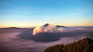 Smoking: View of volcanoes at sunrise, smoking volcano Gunung