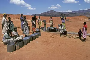 Pump: Villagers collecting water at water pump and new borehole