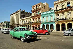 Avenues: Vintage car in front of buildings with colourful
