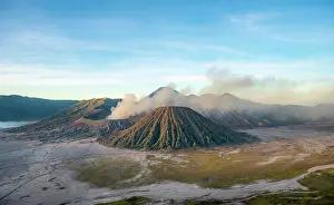 Smoking: Volcanic landscape at sunrise, smoking volcano Gunung