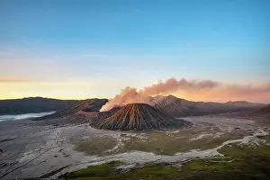 Smoking: Volcanic landscape at sunrise, smoking volcano Gunung