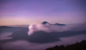 Smoking: Volcanic landscape at sunrise with starry sky, smoking