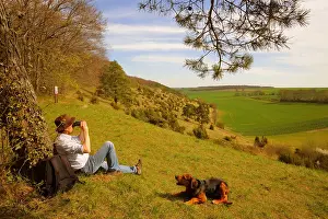 Juniperus: Walker and his dog (Canis familiaris) sitting under
