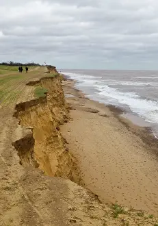 Walkers: Walkers along the edge of Cliff erosion