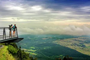 Platform: Walkers on a viewing platform facing the Limagne