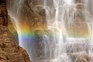Cascading: waterfall and rainbow - water cascading down a
